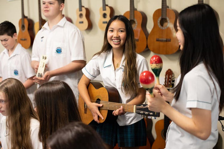 sylvania high school students playing instruments in music class